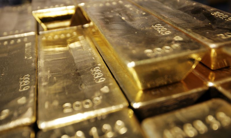 Gold edges up on dollar weakness, but strength in the stock market on vaccine hopes caps gain